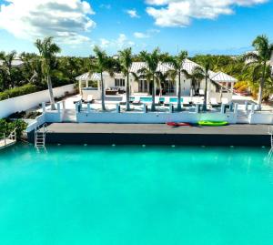 a view of a resort with a body of water at Caribbean Escape Luxe Waterfront Villa with Pool in Long Bay Hills