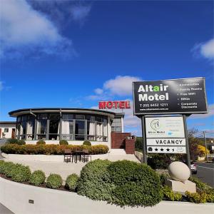 a sign in front of a building with a motel at Altair Motel in Cooma
