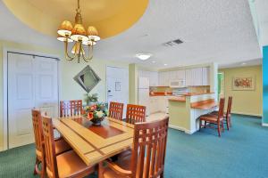 a dining room and kitchen with a table and chairs at Ocean Walk Condominiums in Daytona Beach