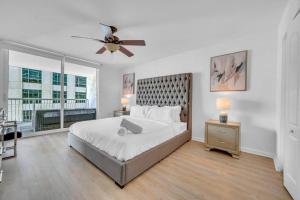 a bedroom with a bed and a ceiling fan at Stunning 1 BDR 1 BTH • Brickell • Bay & City Views in Miami +27 photos