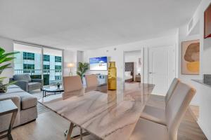 a dining room with a table and a living room at Stunning 1 BDR 1 BTH • Brickell • Bay & City Views in Miami