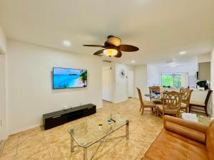 a living room with a ceiling fan and a dining room at Seaside Elegance 3 Mi to FM Beach Paradise Sleep 6 in Fort Myers Beach