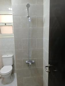 a bathroom with a toilet and a shower stall at بورتو السخنة علي الأكوا بالكاريبيان in Ain Sokhna