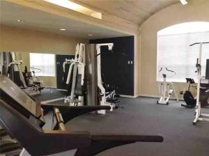 een fitnessruimte met loopbanden en een groot raam bij Private Retreat: Pool, king bed , Comfy Furnishings in Gainesville