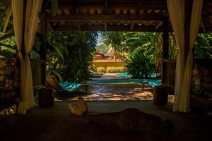 a view from the inside of a house with a pavilion at Alua Camburi in Camburi