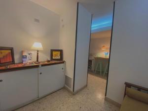 a room with a mirror and a room with a table at Sol del Valle in San Fernando del Valle de Catamarca