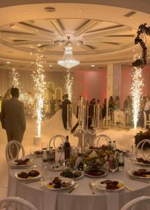 a banquet hall with a table with plates of food at Misk Hotel & Resort in Tirana