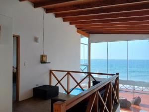 a house with a view of the ocean at Casa de Playa Akas in Canoas de Punta Sal
