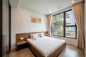 Ένα ή περισσότερα κρεβάτια σε δωμάτιο στο KN Holiday Apartment in Lumiere Riverside