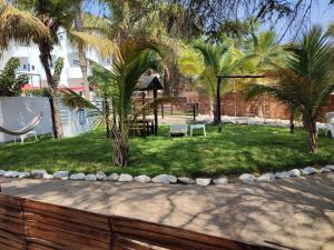 a park with palm trees and a playground at Loki del Mar in Máncora