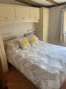 a bedroom with a bed with two pillows on it at Beautiful Scenic Holiday Chalet in Lincolnshire