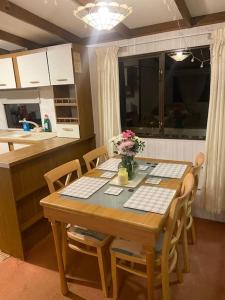 a kitchen with a table and chairs with flowers on it at Beautiful Scenic Holiday Chalet in Lincolnshire