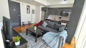 a living room with a couch and a table at Cozy 1BR Apt - Downtown Winnipeg in Winnipeg