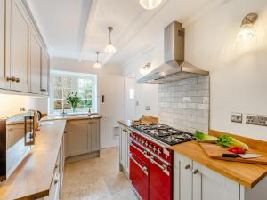 a large kitchen with a red stove top oven at Thirlwell in Ridingmill
