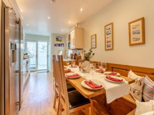 a kitchen and dining room with a table with wine glasses at Casa Musica in Broadstairs