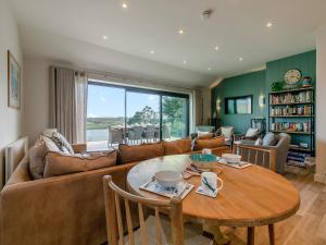 a living room with a couch and a table at Long Commons in Saint Mawes