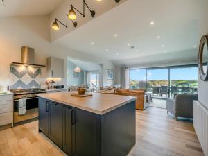 a kitchen with a island in the middle of a room at Long Commons in Saint Mawes