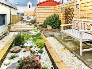 a garden with a bench and a wooden fence at Yardie View in Buckie