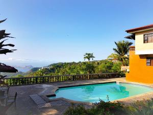 a swimming pool with a view of the mountains at Villa Marinelli Bed and Breakfast in Tagaytay