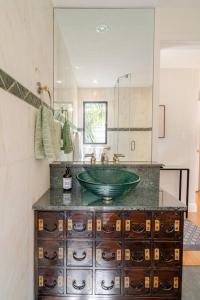 uma casa de banho com um lavatório verde e um espelho em Dreamy 3-Story House : Sunroom + City Skyline View em São Francisco