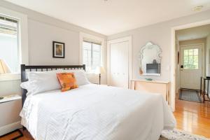 um quarto com uma grande cama branca com lençóis brancos em Dreamy 3-Story House : Sunroom + City Skyline View em São Francisco