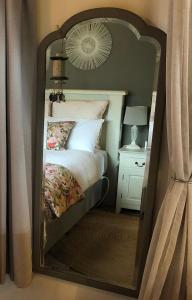 a mirror reflection of a bed in a bedroom at Cosy Country Stay B&B in Matamata