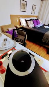 a room with a table with a record player on it at Hotel M-RCURE - Av Paulista - GRAND PLAZA - Deluxe king Studio Veranda - BATH SPA - Executive Class - By LuXXoR in Sao Paulo