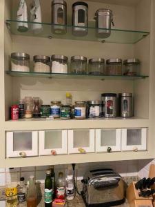 a kitchen shelf filled with lots of pots and pans at Apartamento Orla Praia do Canto in Vitória