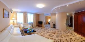 a large living room with a white couch and a living room at Richmond Hotel in Yekaterinburg