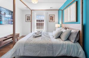 a bedroom with a large bed with blue walls at Cityscape Unit 2 in Newark