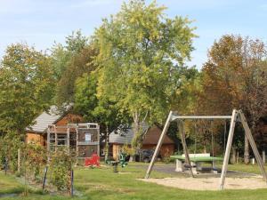 a playground with a swing set in a yard at Gîte Salers, 3 pièces, 4 personnes - FR-1-742-439 in Salers