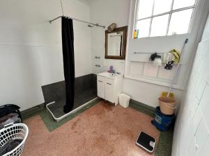 a bathroom with a shower and a sink at Rob Roy Room 8 in Adelaide