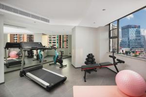 a gym with treadmills and exercise equipment in a building at Yizhi Hotel Changgang Metro Station - Free Shuttle Bus during Canton Fair in Guangzhou