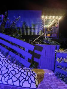 a blue fence with lights on it at night at Alojamiento Rural Altos del Molino in Los Andes