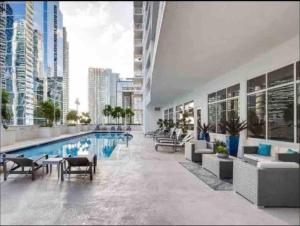 a large building with a swimming pool and a city at Luxe 1 BDR •Brickell• Ocean View in Miami