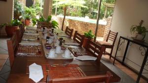 a table set for a meal on a patio at Annas Bed and Breakfast in St Lucia