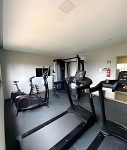 a gym with two treadmills and two exercise bikes at Novissimo Apt Salvador in Salvador