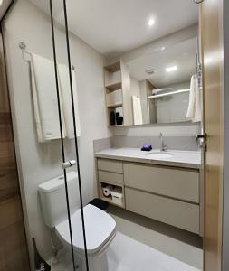 a bathroom with a toilet and a sink at Novissimo Apt Salvador in Salvador