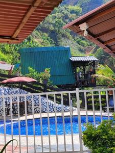 a white fence next to a swimming pool at Alojamiento Rural Altos del Molino in Los Andes