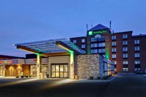 a hotel building with a sign on top of it at Holiday Inn - Mississauga Toronto West, an IHG Hotel in Mississauga