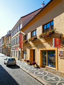 a street with a car parked in front of a building at Hotel U Krále in Jičín