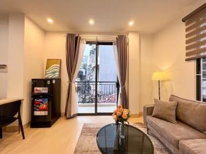 a living room with a couch and a glass table at NINE HOUSING 290 Kim Ma in Hanoi