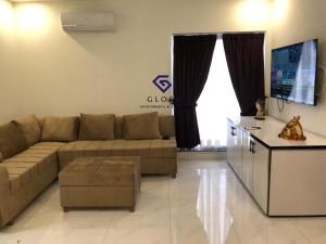 a living room with a couch and a table at 1,2 & 3 BHK Luxury Apartments at Zameen Opal in Lahore