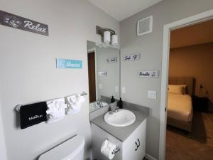 a bathroom with a sink and a toilet and a bed at Luxury Villa Home in Edmonton +64 photos