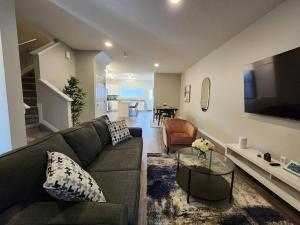 a living room with a couch and a tv at Luxury Villa Home in Edmonton
