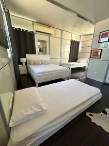 a hotel room with two beds and a mirror at Katherine Farmstay Caravan Park in Katherine