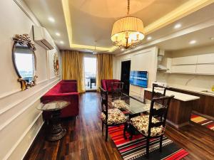 a living room with a red couch and a table at Executive 2BHK Apt in Elysium tower Isb in Islamabad