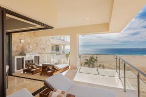 a living room with a view of the ocean at Beachfront 2 Bdrm Condo in Exclusive Diamante Golf in Cabo San Lucas