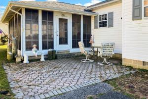a house with a porch with a bench and two chairs at Maplewood --- 30 Bryn Mawr Dr. in Rehoboth Beach