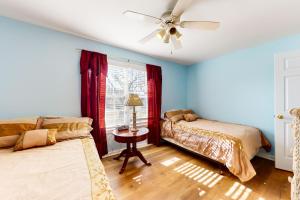 a bedroom with two beds and a ceiling fan at Maplewood --- 30 Bryn Mawr Dr. in Rehoboth Beach